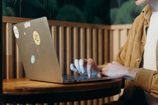 A person coding on a laptop