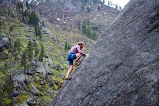 person climbing a mountain