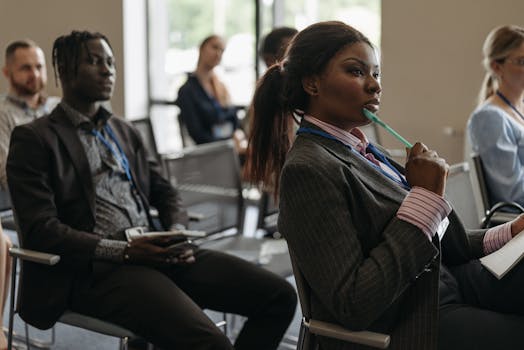 image of a person taking notes during a seminar