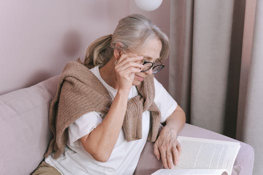 a person reading a book in a cozy setting