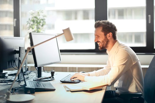 happy person coding on a laptop